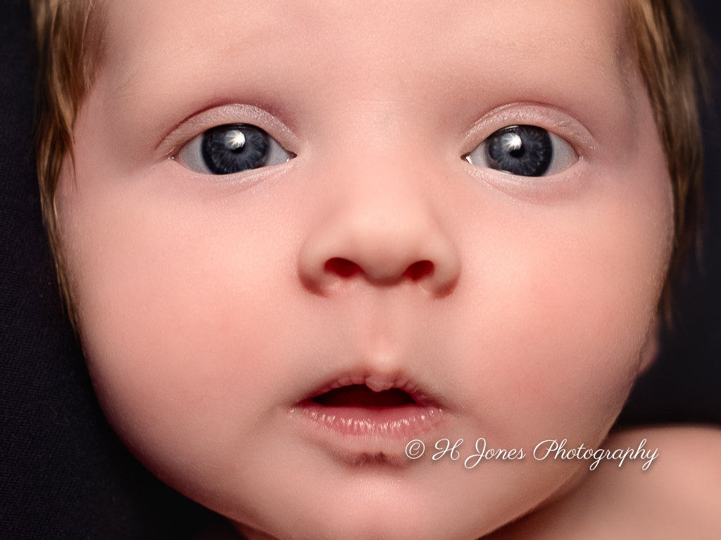 Blue eyed baby face photo watermarked