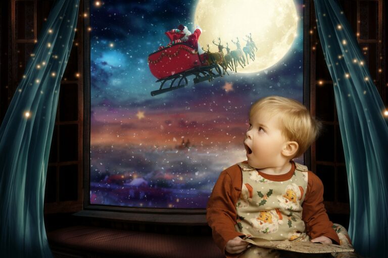 Young boy, wearing Christmas pyjamas, holding a wrapped gift, gazing in awe out of a window, as Santa flies through the sky on his sleigh with his reindeer. at a Hampshire Christmas Photoshoot.