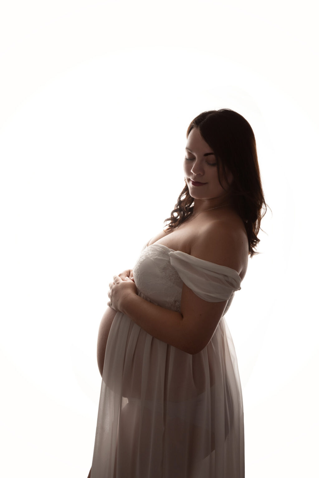 Pregnant lady posing for maternity photoshoot at H Jones Photography studio in Andover.