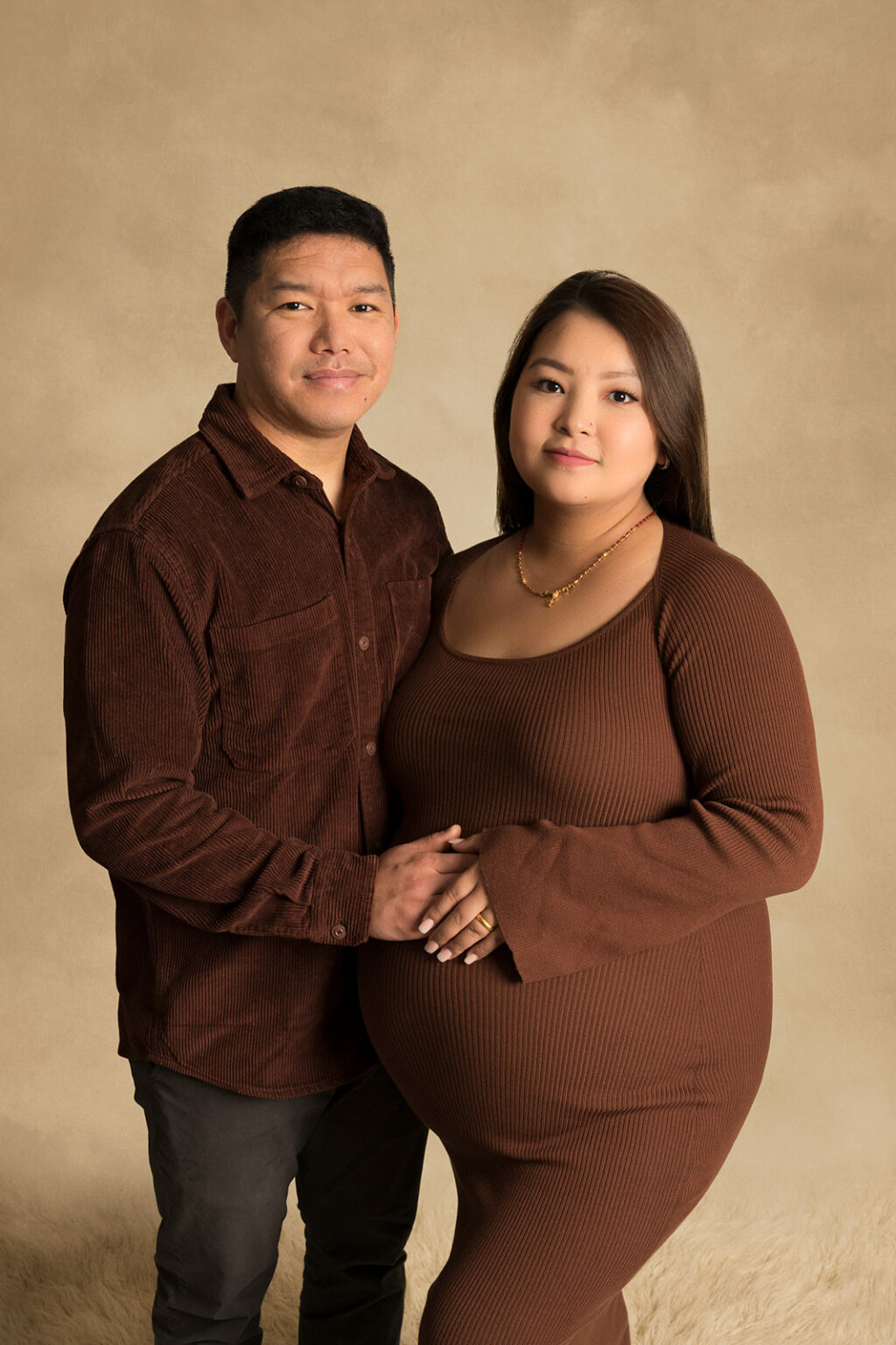 Couple expecting baby posing for maternity shoot at photo studio near Tidworth