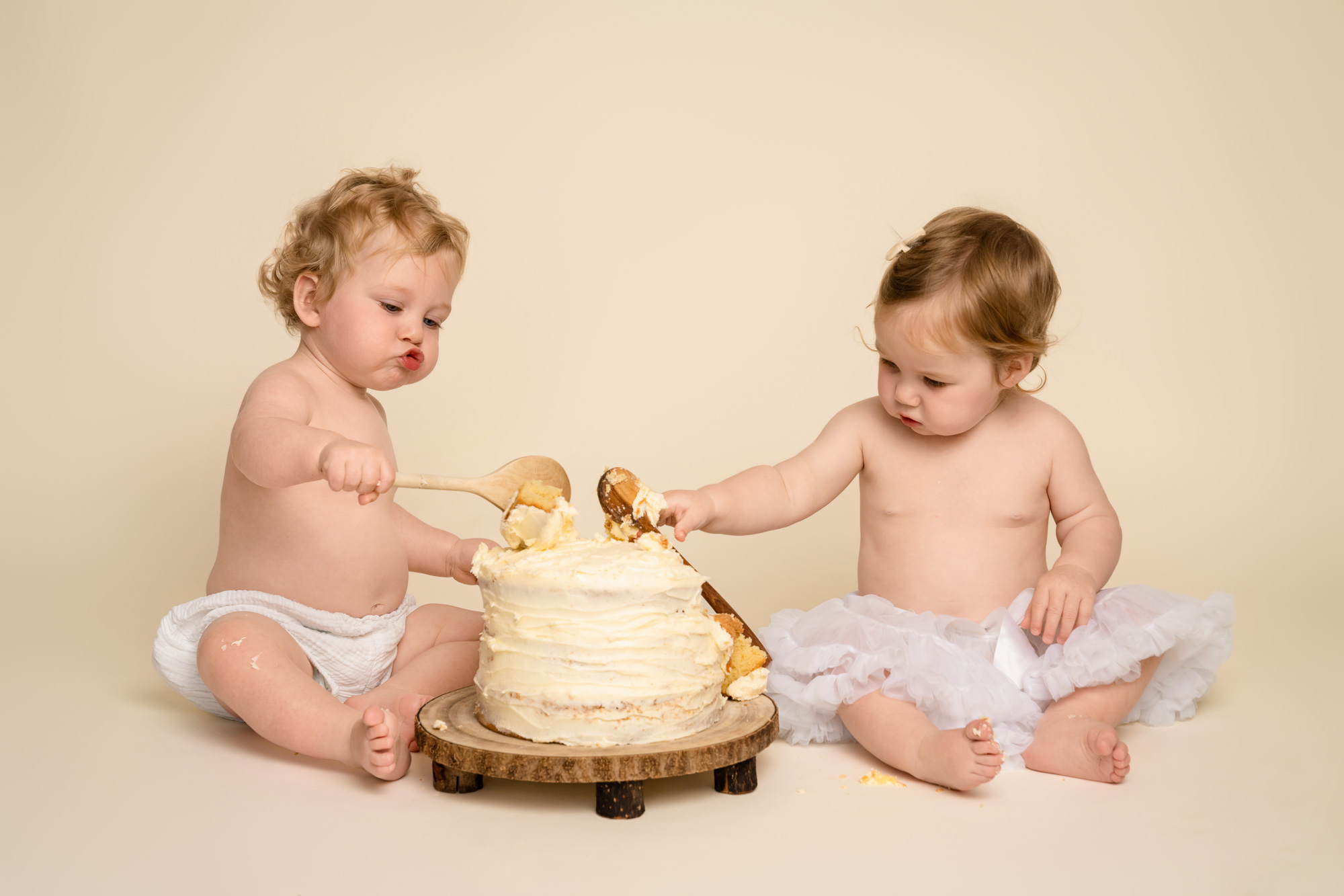 Twin brother and sister at first birthday cake smash photoshoot near Southampton