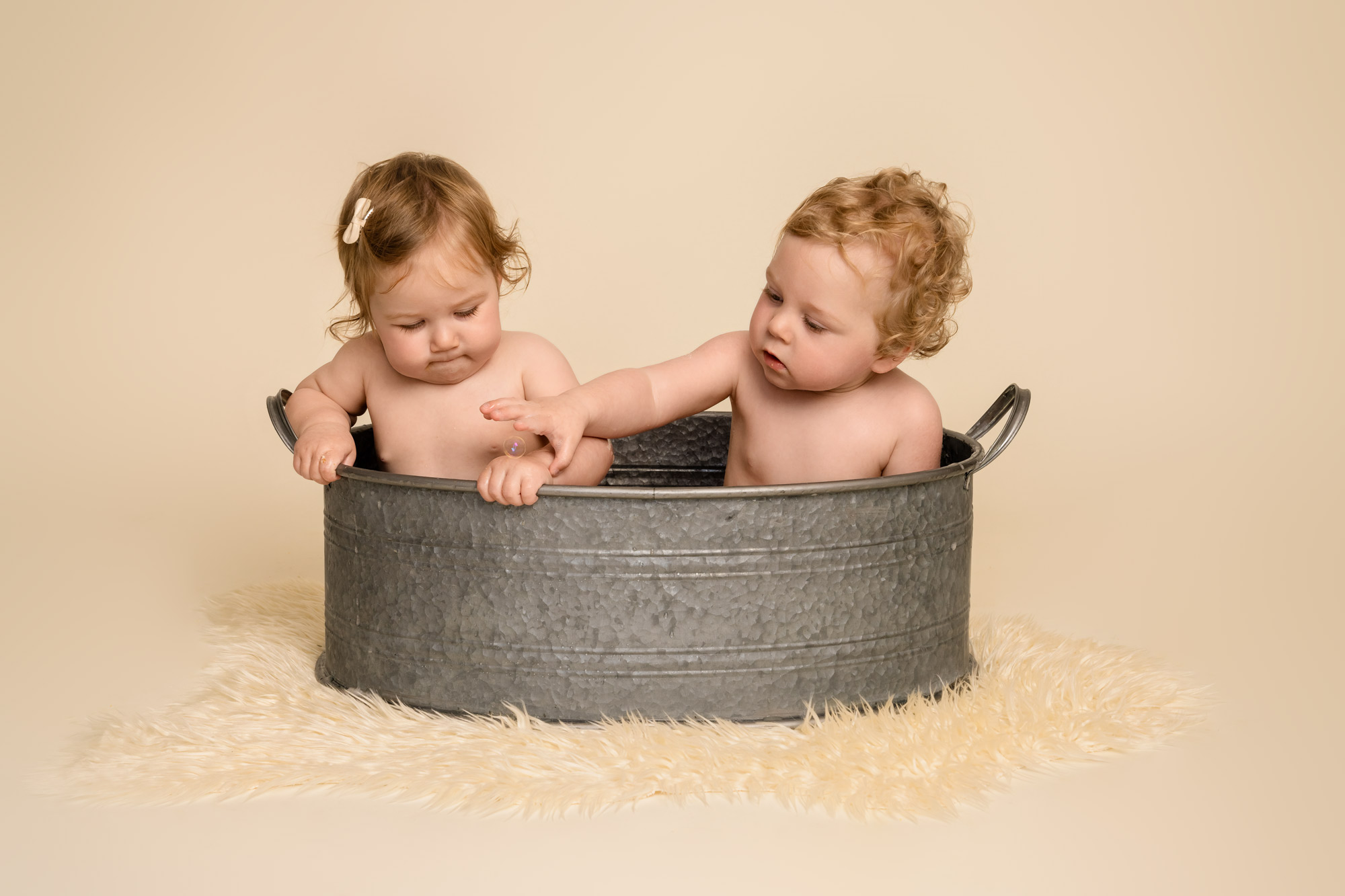 Twins in a vintage bathtub following a cake smash photoshoot near Winchester