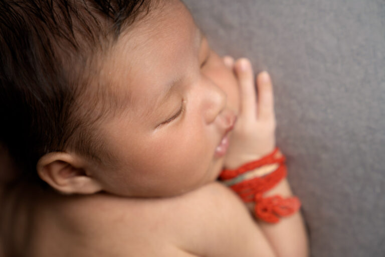 Close up of baby's face, taken by Hampshire newborn photographer Helen Jones