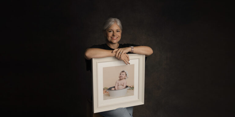 A Christmas bauble featuring a family photo by H Jones Photography