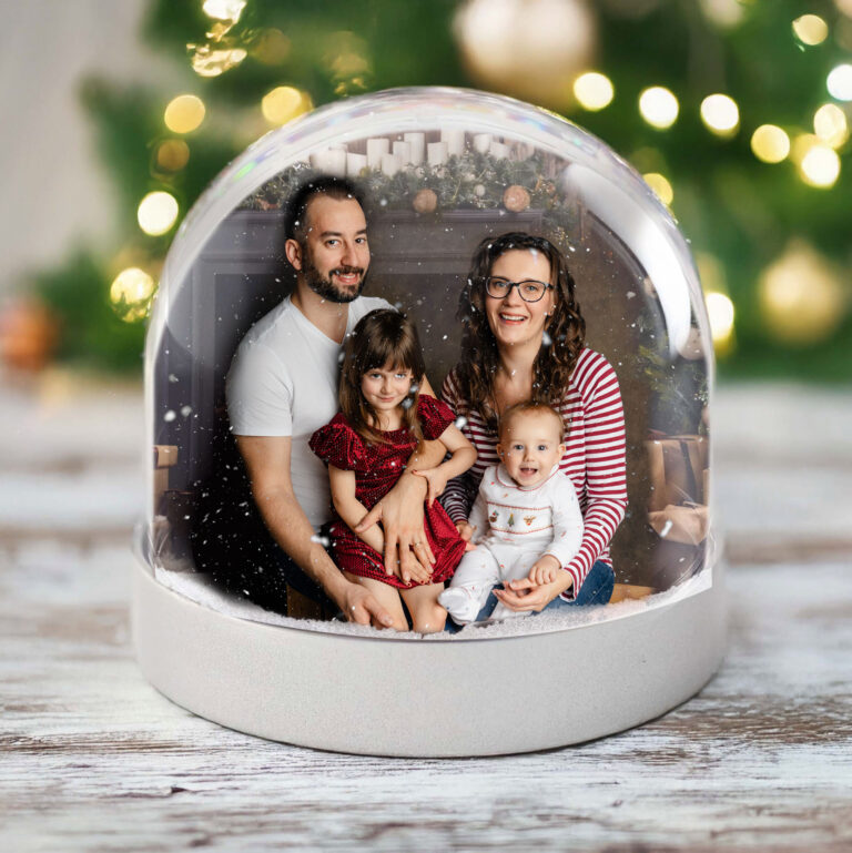 A snow globe featuring a Christmas family photo by H Jones Photography