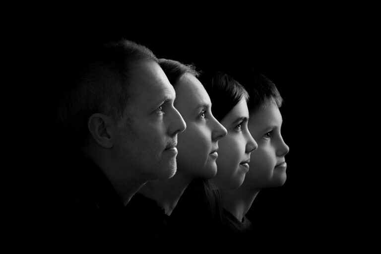 black and white photo showing side profiles of four family members