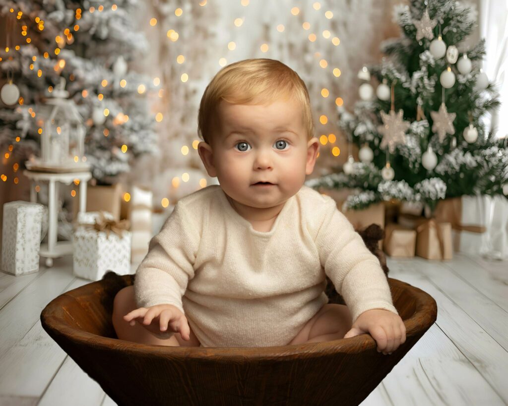 Young boy sitting in a magical christmas themed room at Hampshire photoshoot.