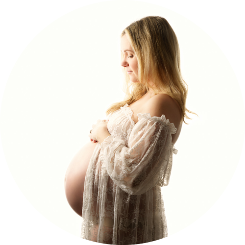 Soft, light-filled maternity portrait of an expectant mother gently cradling her baby bump, photographed in profile against a clean white background. The image has a calm, timeless feel, highlighting connection, anticipation and the beauty of pregnancy, captured by a professional maternity photographer in Hampshire.