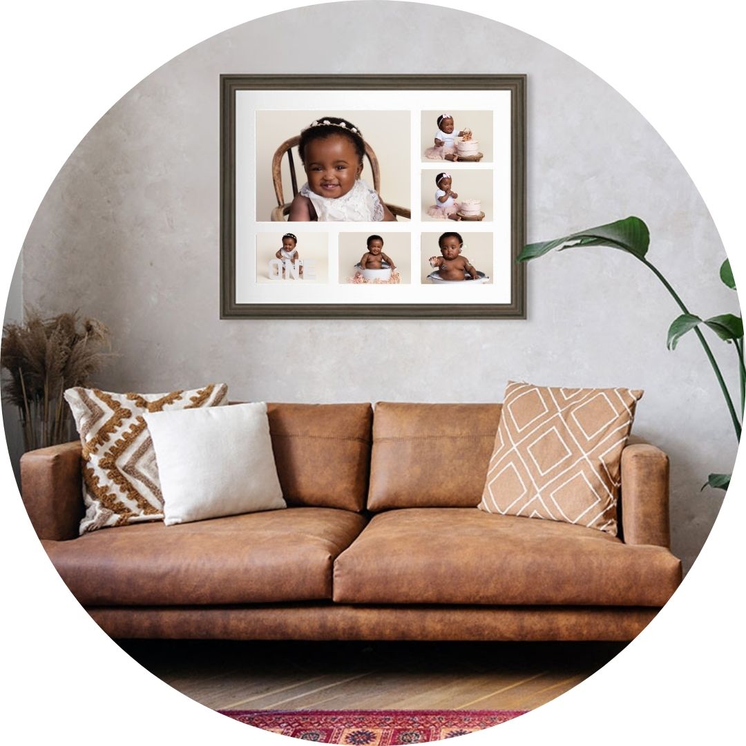 Framed multi-image cake smash collage featuring a baby’s first birthday portraits, professionally displayed as wall art above a sofa in a neutral family living room, photographed by a Hampshire photographer.