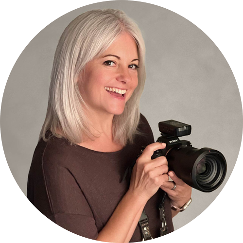 Helen Jones of H Jones Photography, Hampshire, smiling and holding her Sony camera.