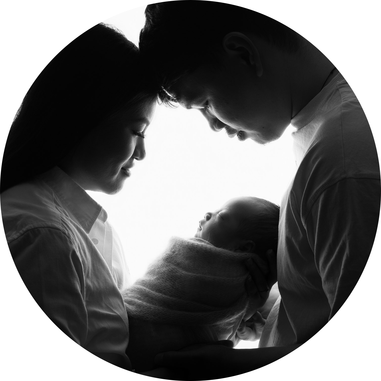 Black and white silhouette portrait of parents holding their newborn baby during a natural newborn photoshoot in Andover, Hampshire