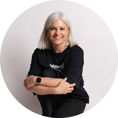 Relaxed studio portrait of Helen Jones, photographer based near Andover, Hampshire, sitting casually and smiling at the camera.