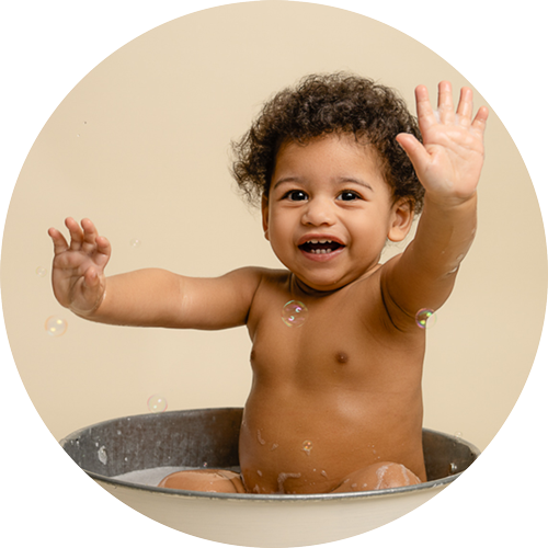 Boy in a splash tub following a cake smash photoshoot.
