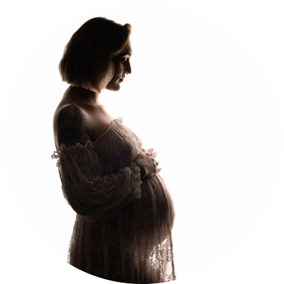 Elegant silhouette maternity portrait of an expectant mother in a flowing gown, photographed by a Hampshire maternity photographer serving Basingstoke and surrounding areas.