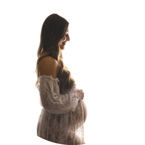 Elegant backlit maternity portrait of an expectant mother in a lace gown, photographed by a maternity photographer serving Salisbury and Wiltshire families.