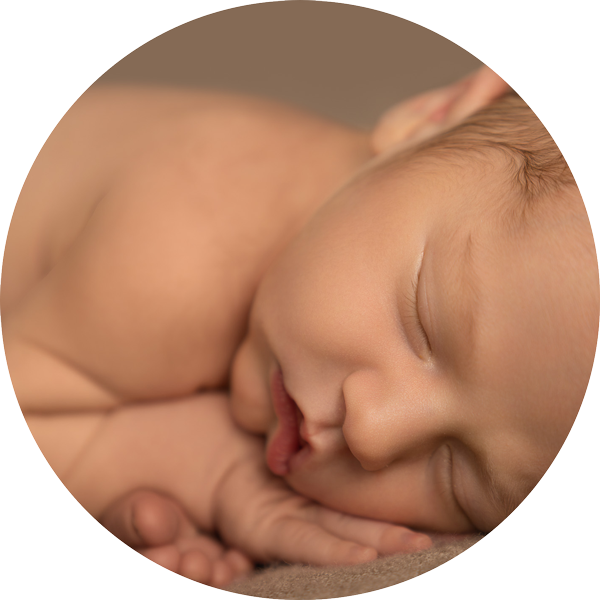 Close-up portrait of a sleeping newborn baby with delicate features and tiny hands, photographed by a Hampshire newborn photographer serving Basingstoke and surrounding areas.