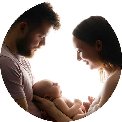 Mother and father holding their newborn baby during a relaxed newborn photography session at H Jones Photography's Hampshire studio near Andover.