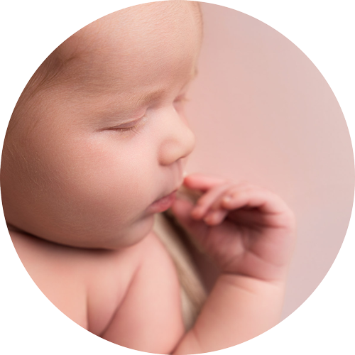Delicate close-up newborn portrait showing a sleeping baby's tiny features and fingers, photographed by a Winchester newborn photographer.