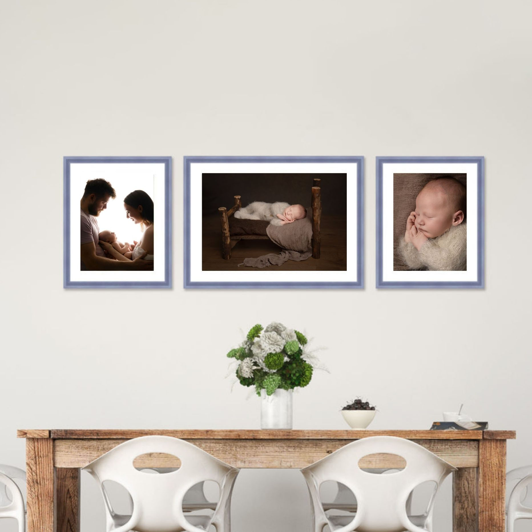 Framed newborn photography wall art collection featuring family and baby portraits displayed as a gallery wall in a Hampshire home